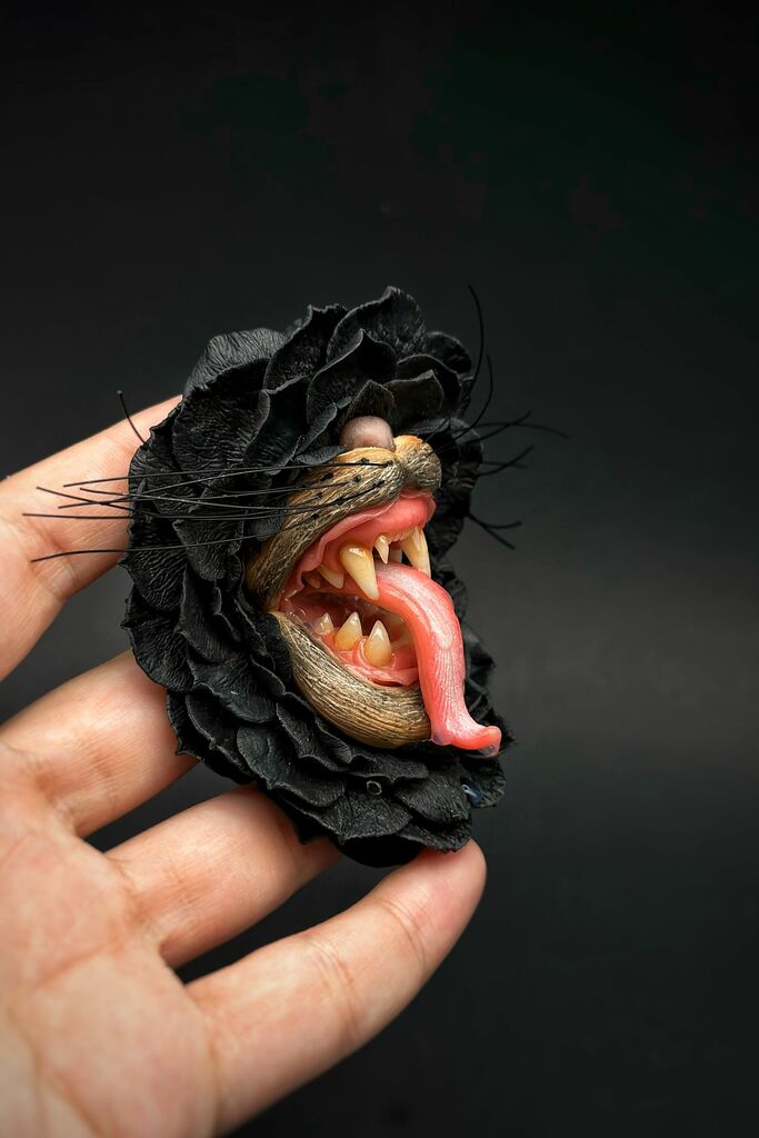 Handmade polymer clay Black Flower With Animal Teeth, a unique wearable art piece by ioArtStudio