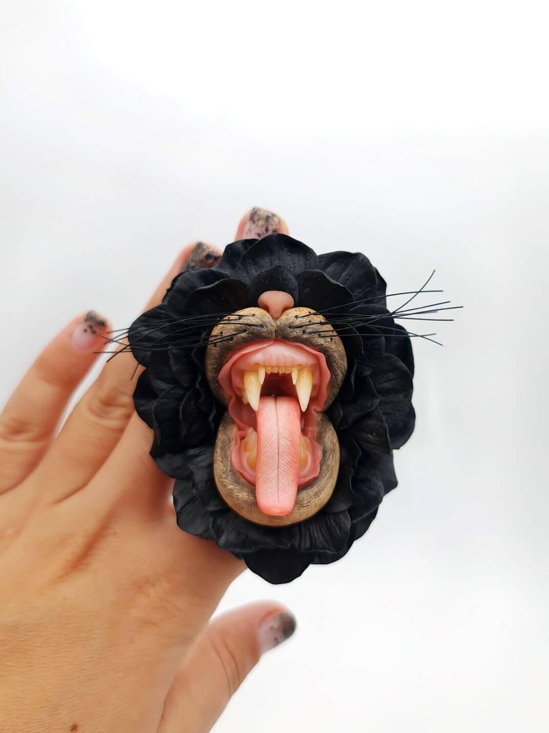 Handmade polymer clay Black Flower With Animal Teeth, a unique wearable art piece by ioArtStudio