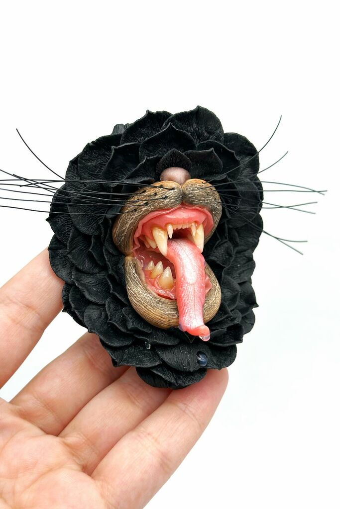 Handmade polymer clay Black Flower With Animal Teeth, a unique wearable art piece by ioArtStudio