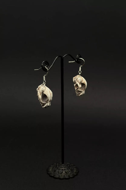 Cat Skulls Earrings in stud or dangle variations, featuring realistic cat skull and skeleton designs by ioArtStudio