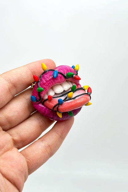 lips with christmas light bulbs around it , Handmade with polymer clay Wearable Artwork by ioArtStudio