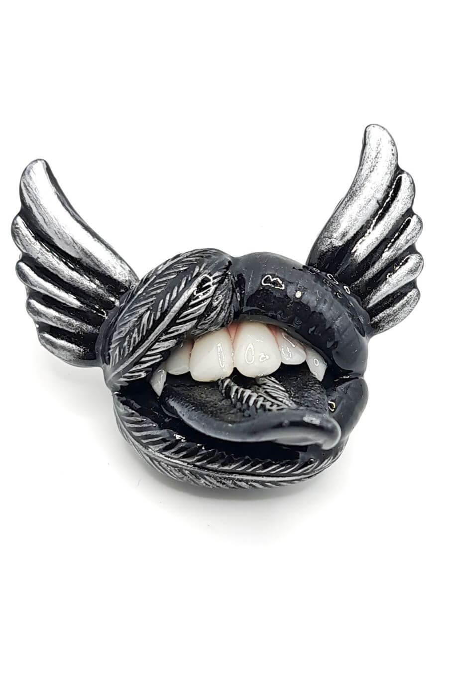 Black lips with fangs  and silver accents, embraced by the allure of Gothic jewelry, adorned with black angel wings,  Wearable Artwork by ioArtStudio