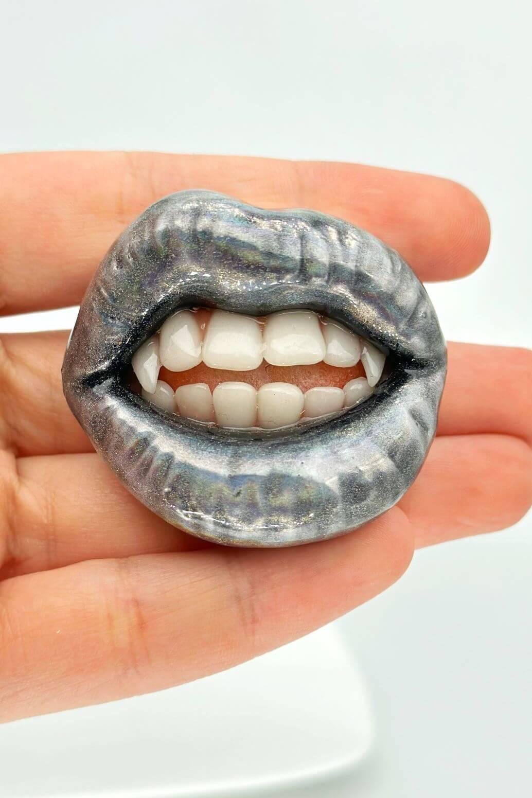 Holographic glitter lips with vampire fangs, hand-sculpted wearable art piece, crafted from polymer clay  by ioArtStudio