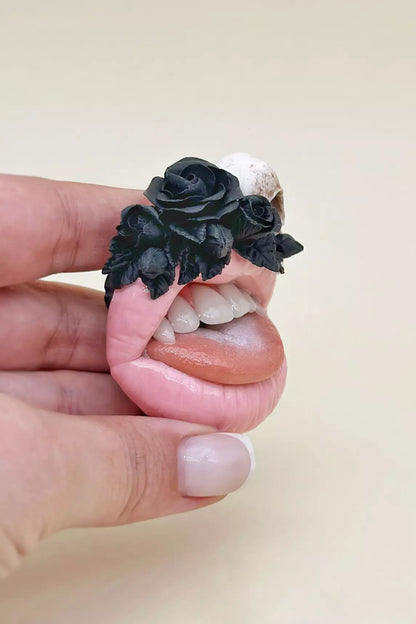 Handmade jewelry by ioArtStudio,  pink lips with raven skull and  black roses,  embodying dark romance 