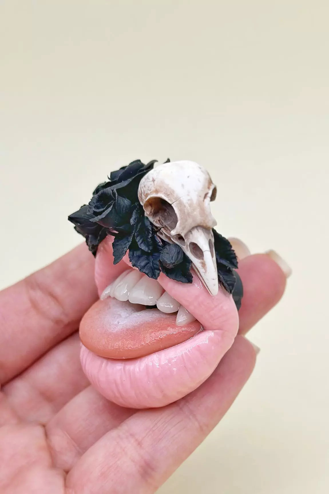 Handmade jewelry by ioArtStudio,  pink lips with raven skull and  black roses,  embodying dark romance 