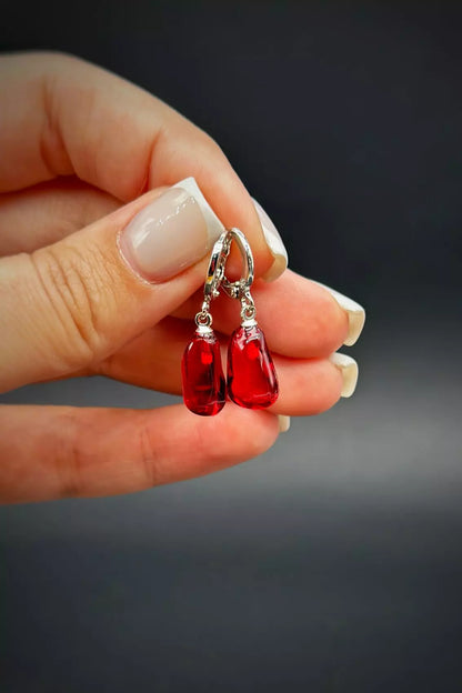 Pomegranates Leverback Earrings Set: one earring is an epoxy seed, and the other is a polymer clay whole pomegranate, with leverbacks