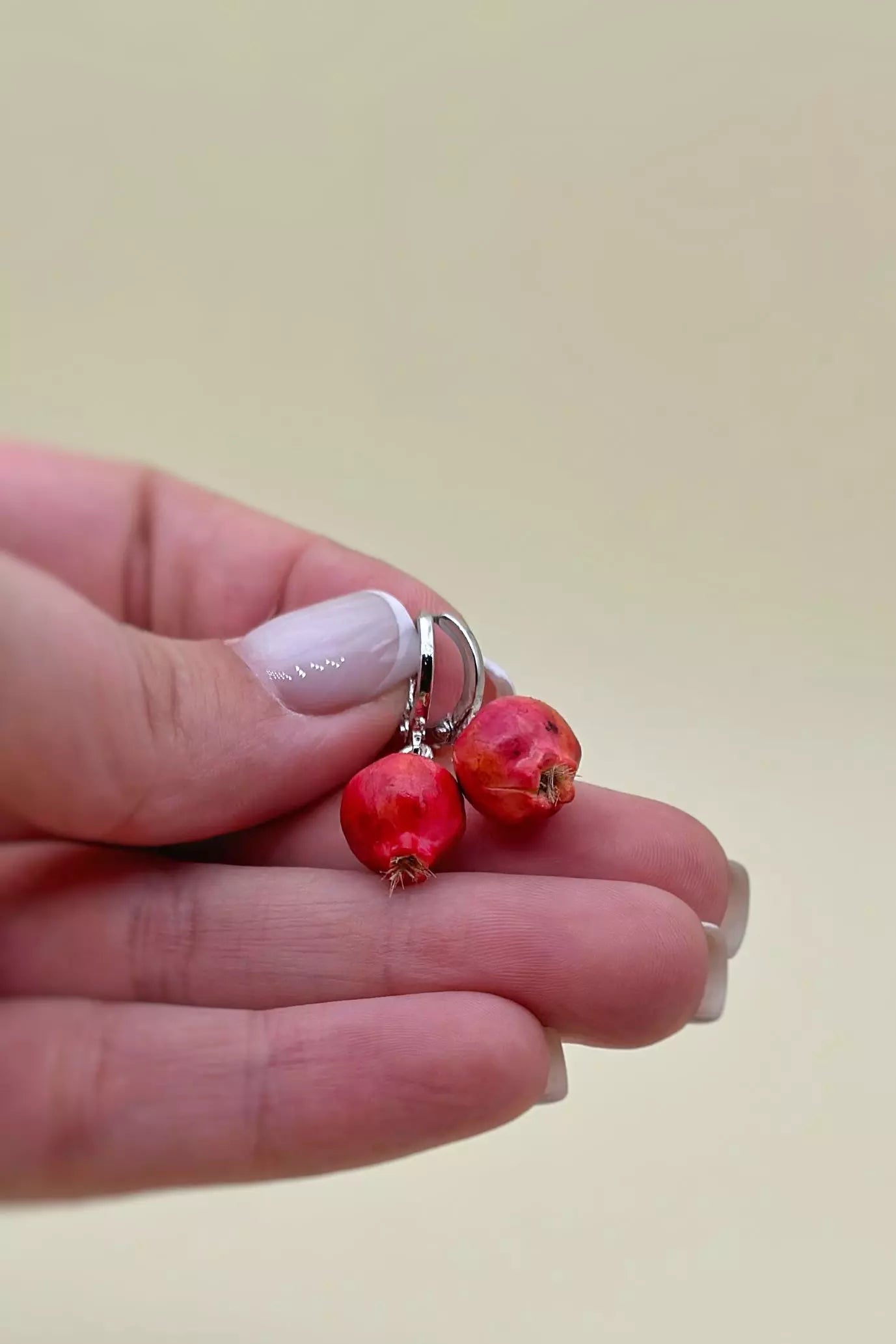 Pomegranates Leverback Earrings Set: one earring is an epoxy seed, and the other is a polymer clay whole pomegranate, with leverbacks