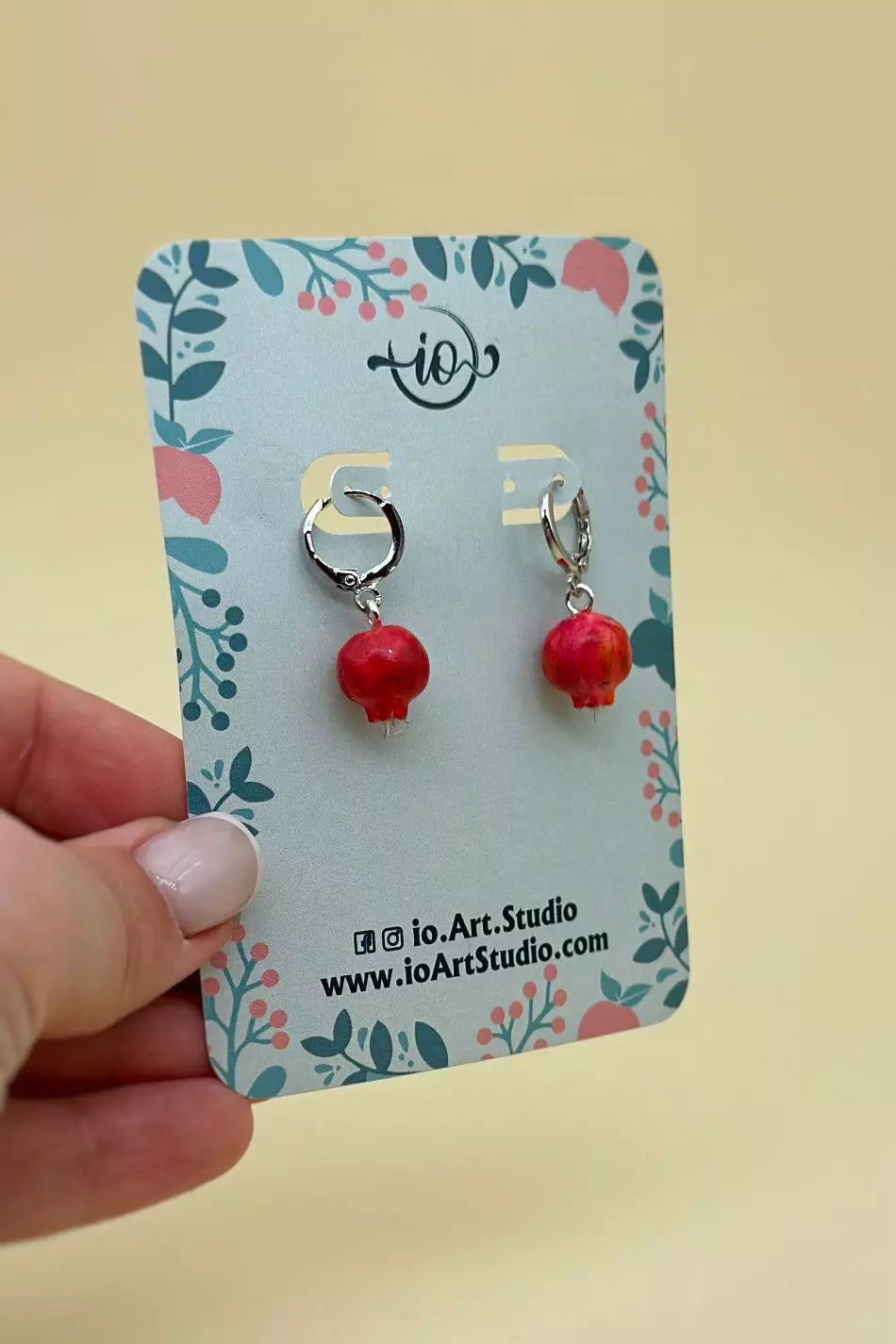 Pomegranates Leverback Earrings Set: one earring is an epoxy seed, and the other is a polymer clay whole pomegranate, with leverbacks