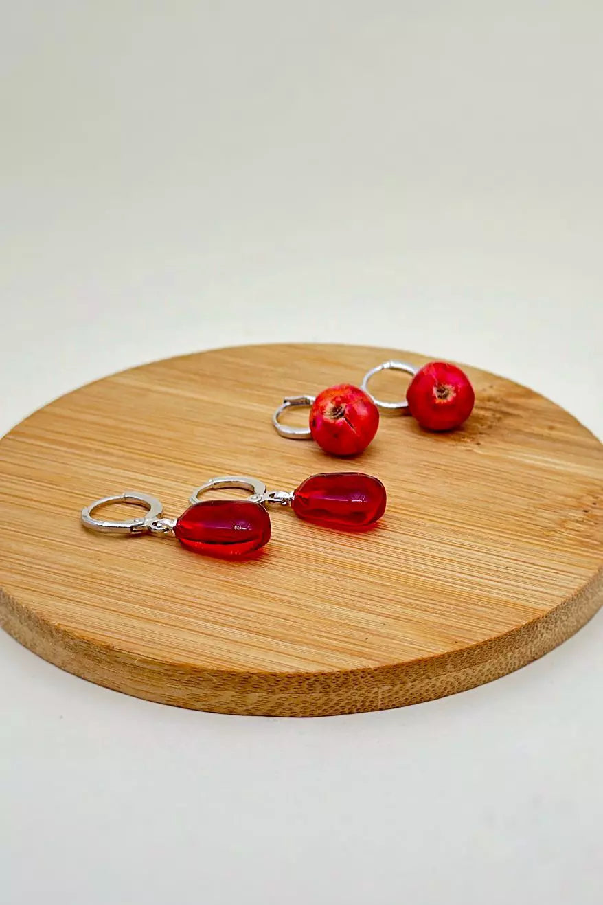 Pomegranates Leverback Earrings Set: one earring is an epoxy seed, and the other is a polymer clay whole pomegranate, with leverbacks