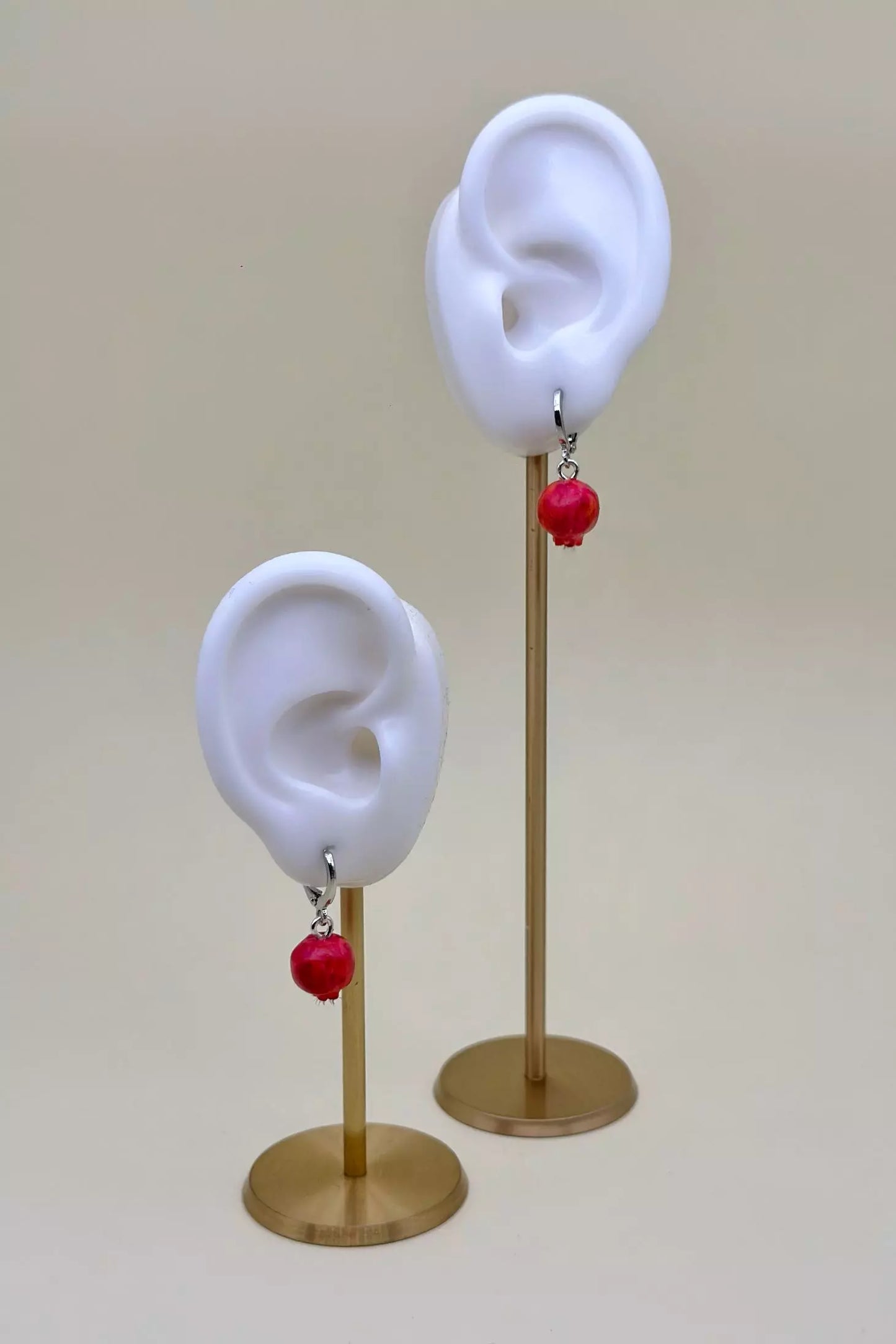 Pomegranates Leverback Earrings Set: one earring is an epoxy seed, and the other is a polymer clay whole pomegranate, with leverbacks