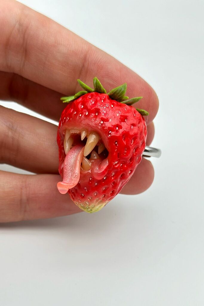 Strawberry Adjustable Ring With Tiger Teeth sculpted with polymer clay. A unique and eye-catching wearable art by ioArtStudio