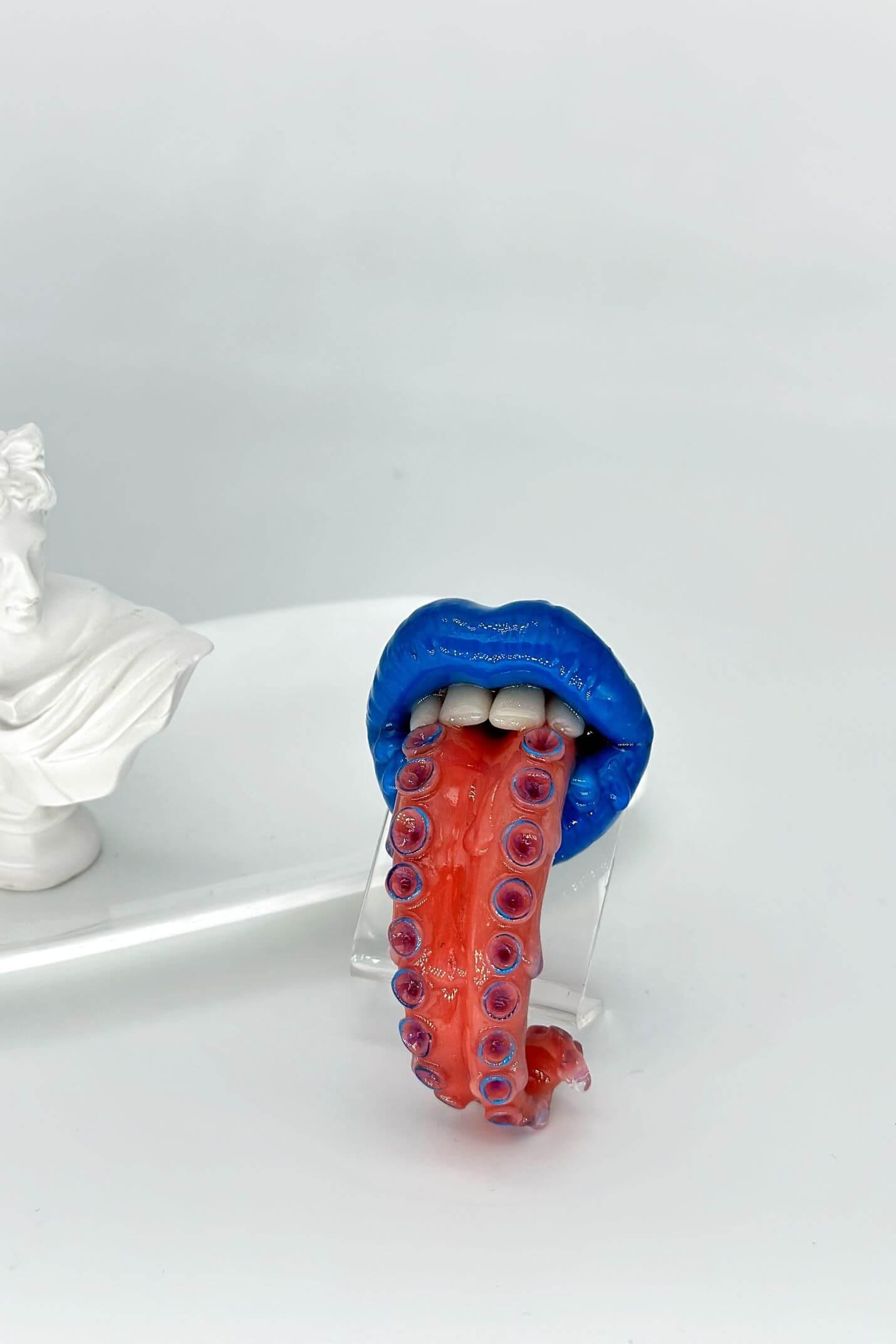 Tentacle tongue with blue lips hand-sculpted wearable art piece, crafted from polymer clay  by ioArtStudio