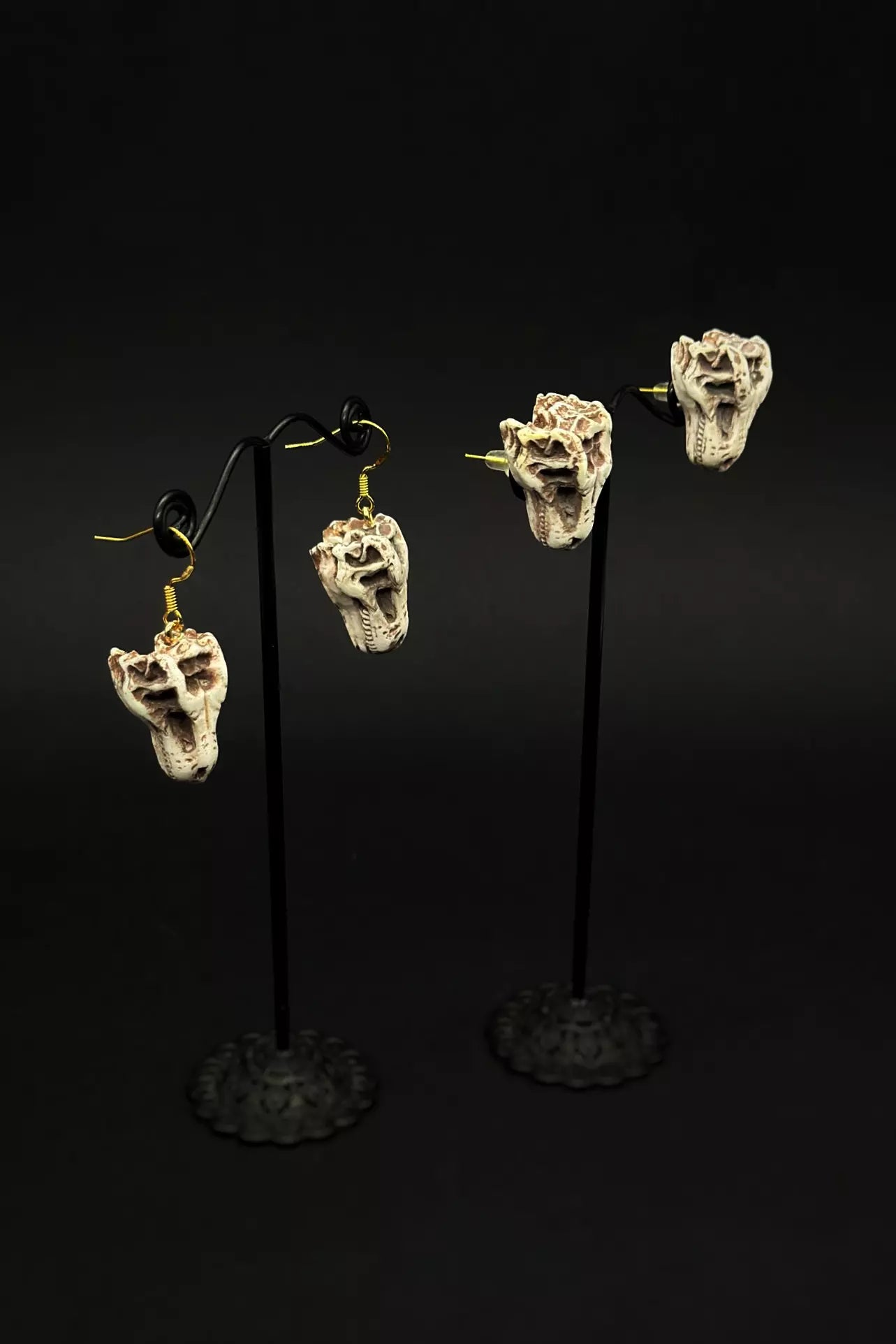 Trex Head Earrings in stud or dangle variations, featuring realistic dinosaur skull and skeleton designs by ioArtStudio