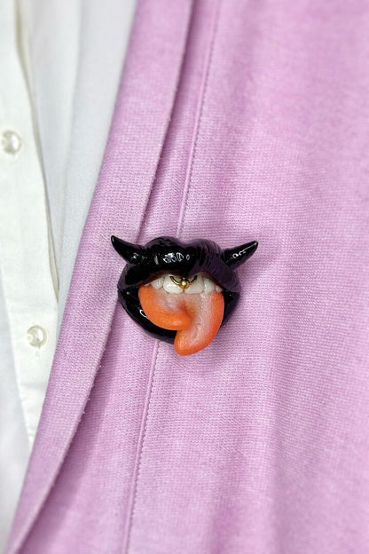 Handmade polymer clay black lips with split tongue, horns, and smile piercing, a unique and eye-catching wearable art by ioArtStudio