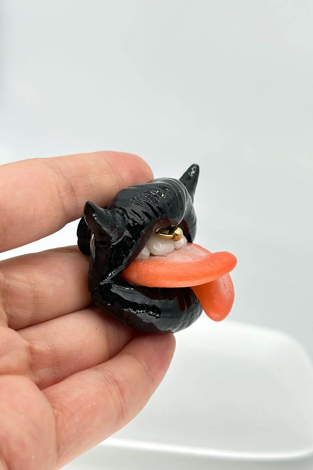 Handmade polymer clay black lips with split tongue, horns, and smile piercing, a unique and eye-catching wearable art by ioArtStudio