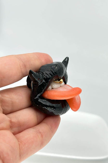 Handmade polymer clay black lips with split tongue, horns, and smile piercing, a unique and eye-catching wearable art by ioArtStudio